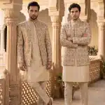 Step into timeless elegance with this premium Prince Coat crafted from luxurious silk-based fabric and enhanced with intricate digital thread embroidery.