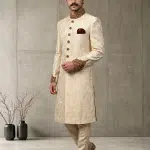 Elevate your wedding and festive look with this Luxury IvoryJamawar Sherwani, crafted from premium Jamawar fabric featuring an elegant woven pattern.