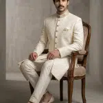 Elevate your wedding style with this luxurious ivory silk-based sherwani, designed with exquisite digital thread work embroidery.