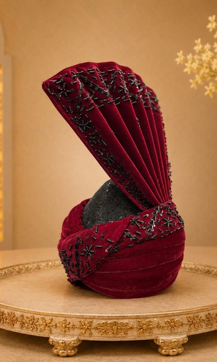 Complete your royal wedding look with this Luxury Maroon Velvet Groom Turban, expertly handcrafted from premium velvet fabric and adorned with elegant black bead embellishments.