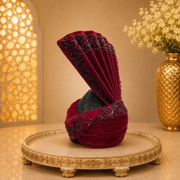 Luxury Maroon Velvet Embellished Groom Turban Premium Wedding Safa for Men Complete your royal wedding look with this Luxury Maroon Velvet Groom Turban, expertly handcrafted from premium velvet fabric and adorned with elegant black bead embellishments.