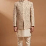 Kids Prince Coat in champagne beige with elegant embroidery, hidden buttons, and ivory raw silk kurta pajama for boys’ wedding wear.