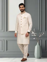 Men's off white Jamawar waistcoat with handmade golden embroidery, paired with traditional kurta pajama.