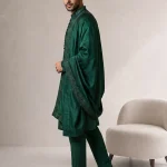 Male model wearing a luxury emerald green embroidered kurta pajama with a matching embellished shawl for weddings and festive occasions.