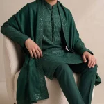 Boys dark green embroidered kurta pajama in premium raw silk, custom-made traditional wear for weddings and Eid.
